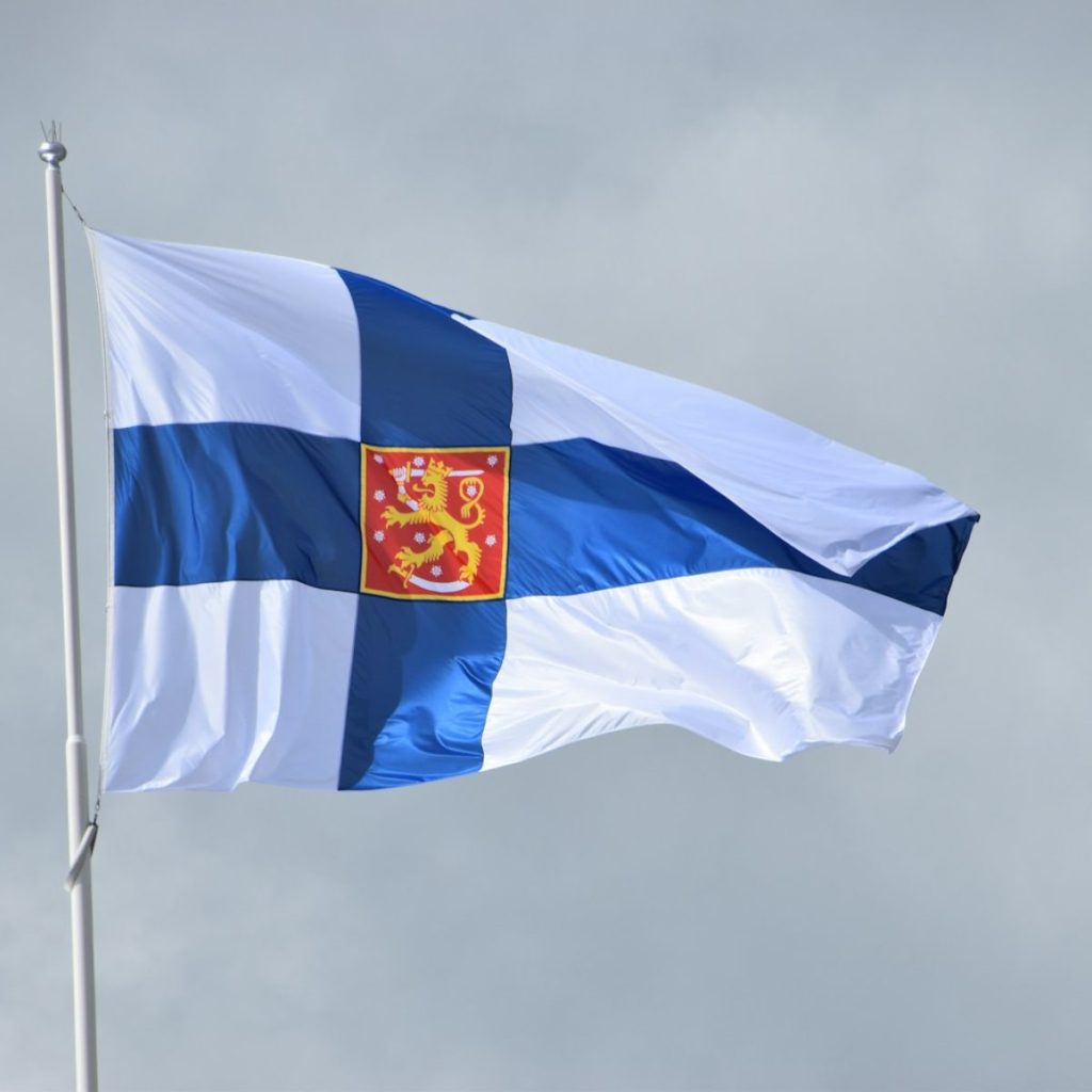 a blue and white flag flying in the wind