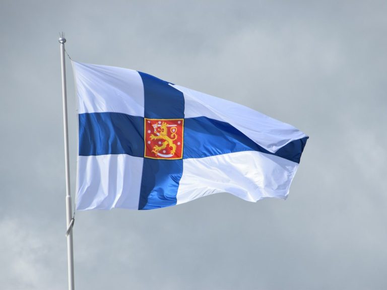 a blue and white flag flying in the wind